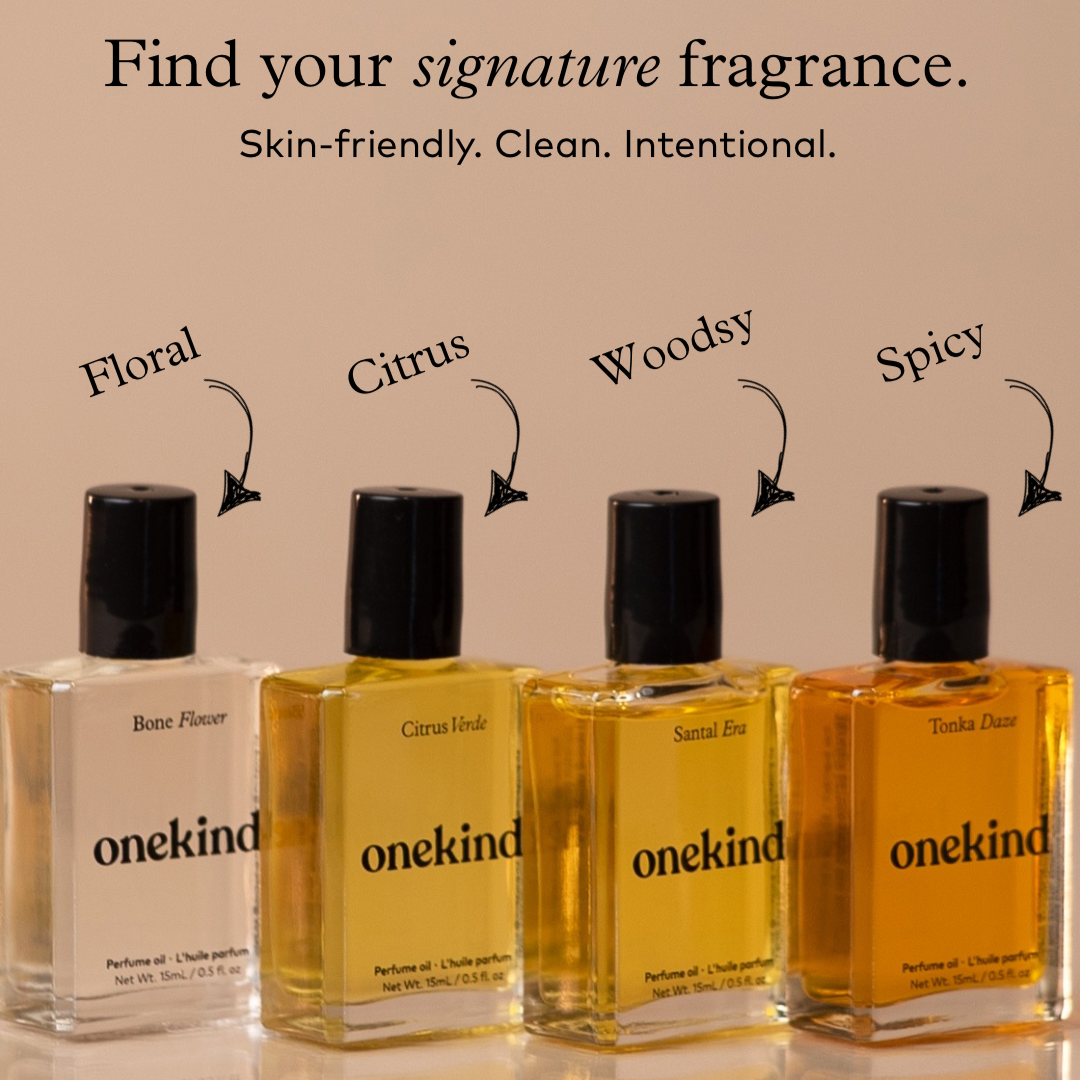 Four bottles of onekind perfume with different scents on a beige background
