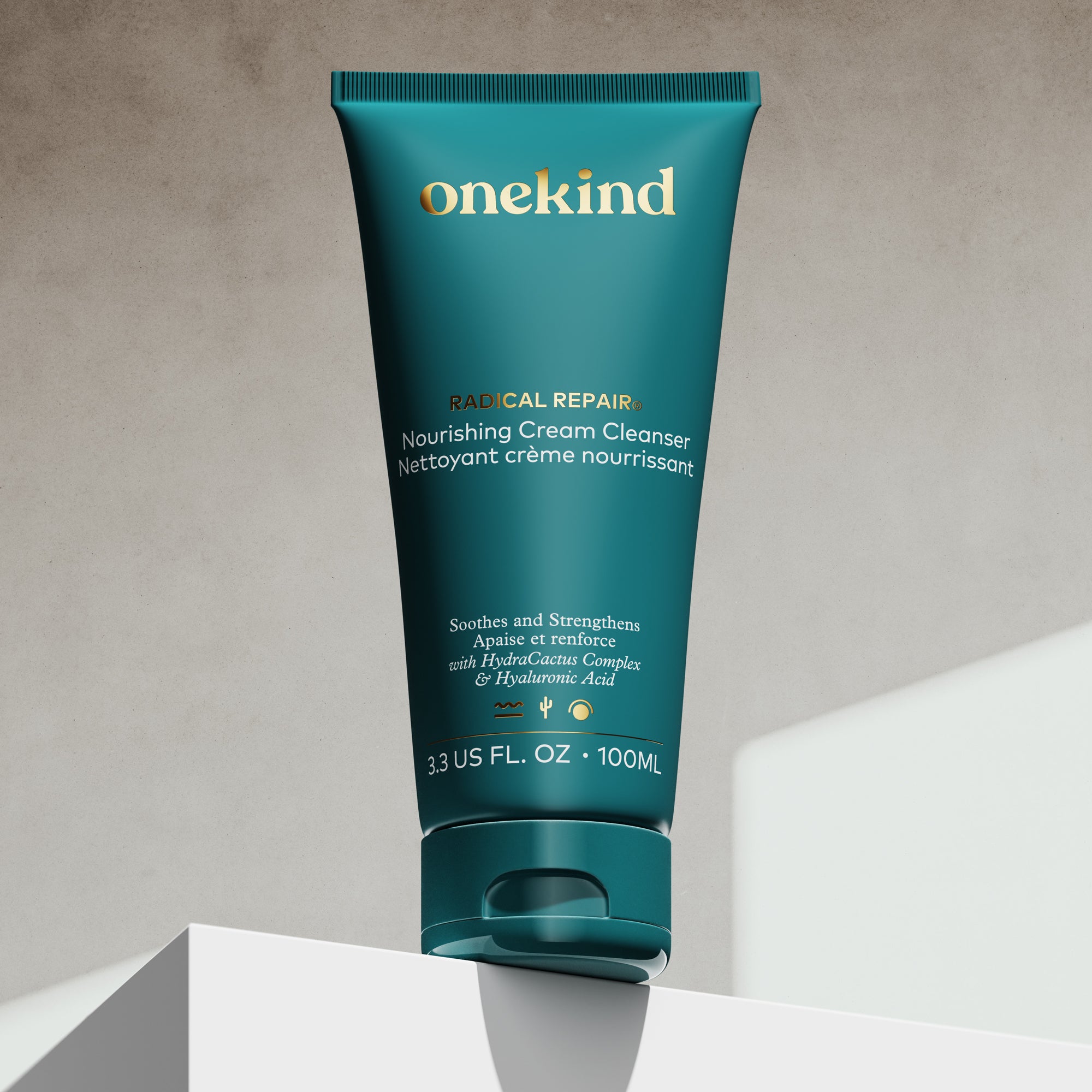 Onekind nourishing cream cleanser tube on a neutral background